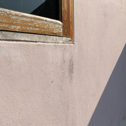 Low angle view of window on wall of building