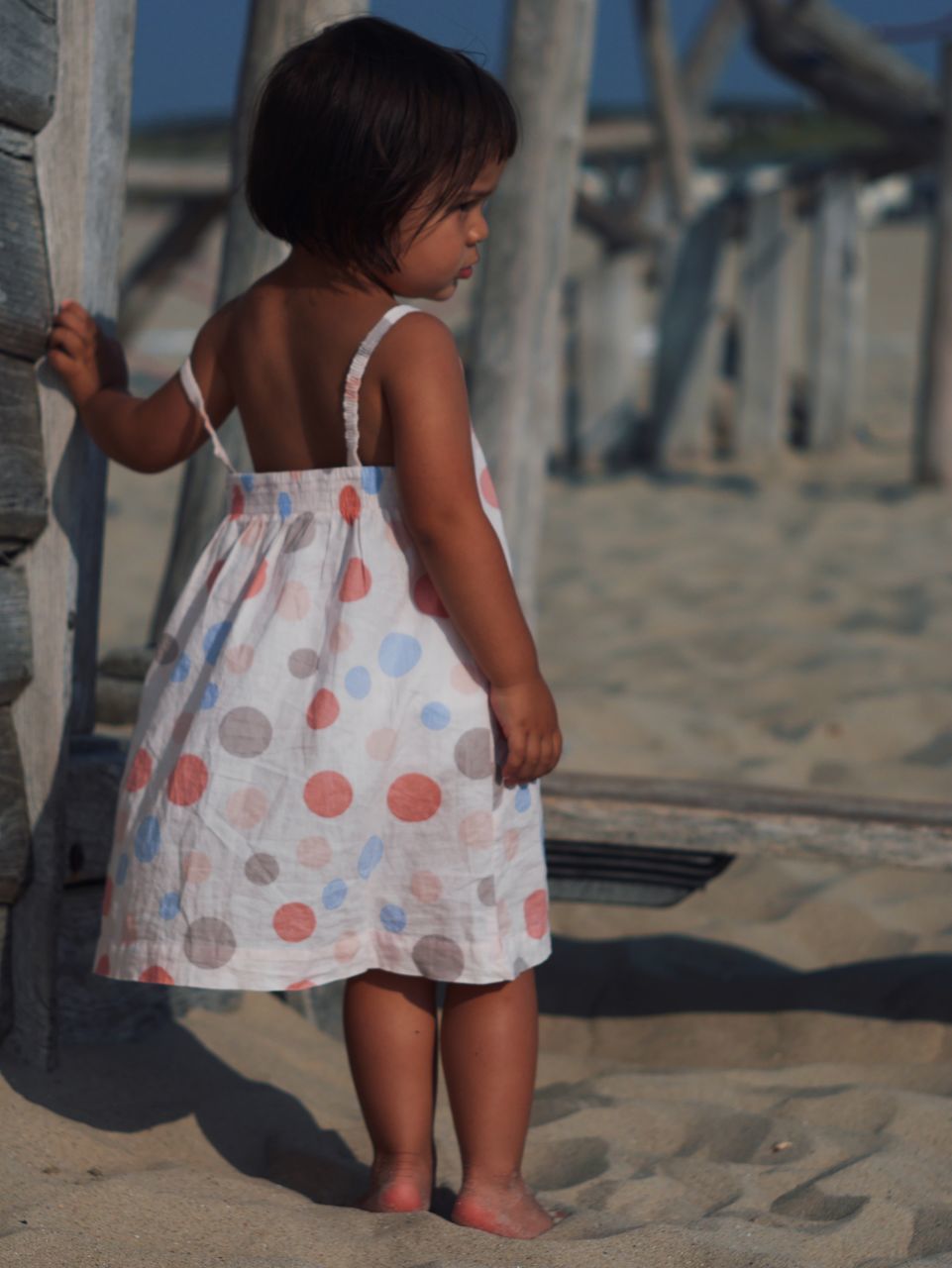 childhood, child, dress, one person, full length, women, female, spring, blue, beach, rear view, standing, sand, day, clothing, photo shoot, nature, person, casual clothing, fashion, innocence, land, toddler, leisure activity, emotion, outdoors, summer, barefoot, looking, cute, walking, lifestyles, holiday, sunlight, hairstyle, trip, architecture, vacation, focus on foreground, shadow