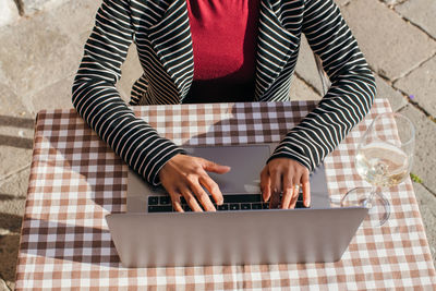 Young businesswoman typing on laptop computer, close up