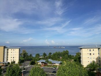 High angle view of buildings and sea against sky