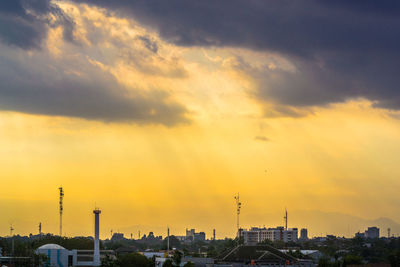 View of cityscape against cloudy sky