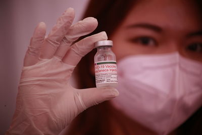 Close-up of human hand holding bottle