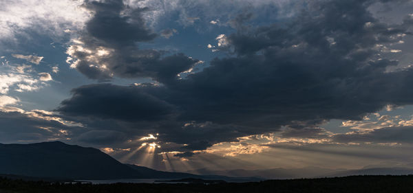 Sunlight streaming through clouds during sunset