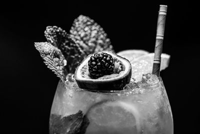 Close-up of drink on table against black background