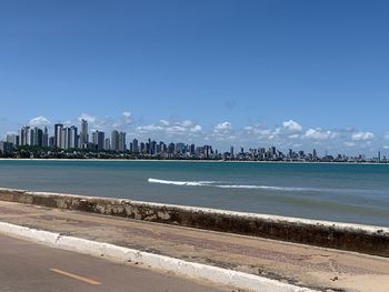 Scenic view of sea and buildings against sky