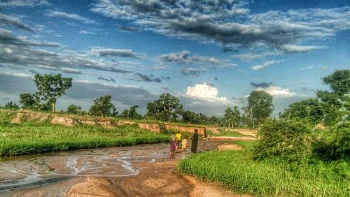 Scenic view of landscape against cloudy sky