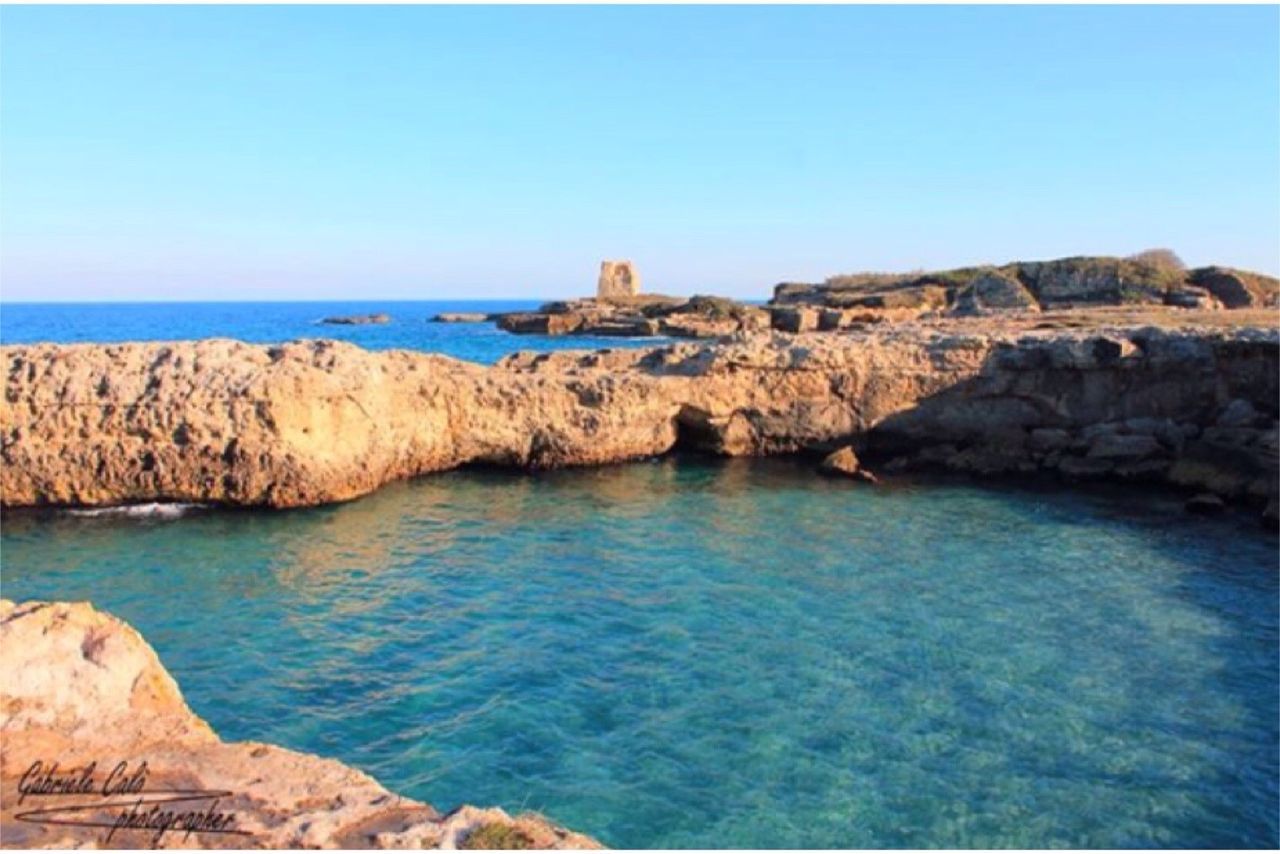 sea, blue, scenics, clear sky, rock - object, rock formation, tranquility, water, horizon over water, nature, sky, beauty in nature, day, outdoors, no people, architecture, beach