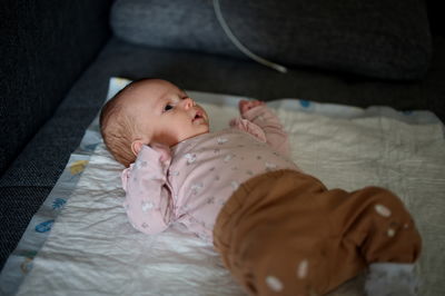 Portrait of cute baby boy sleeping on bed at home