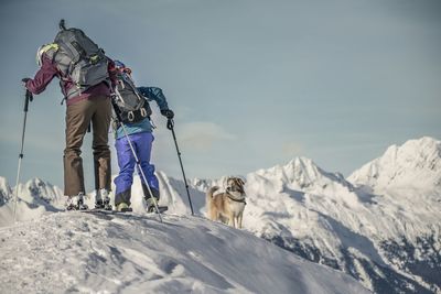 Full length of woman standing on mountain against sky