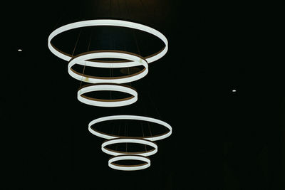 Close-up of illuminated lamp against black background