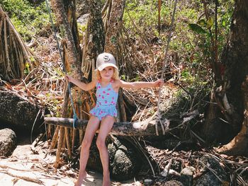 Portrait of woman against trees in forest