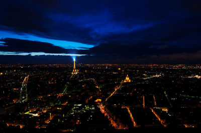 High angle view of city lit up at night