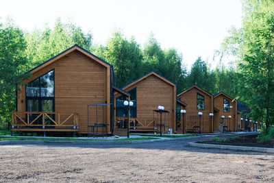 Houses by building against clear sky