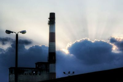 Low angle view of building against cloudy sky