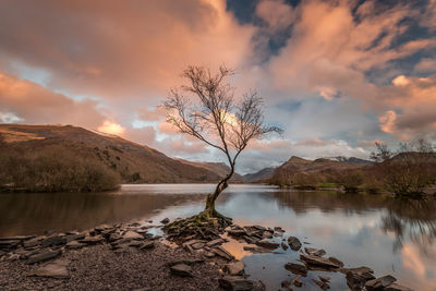 Scenic view of lake against sky at sunset