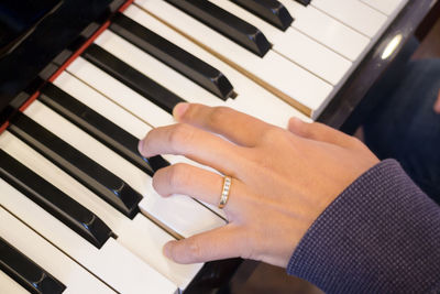 Close-up of person playing piano