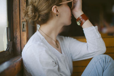 Midsection of young woman traveling in train