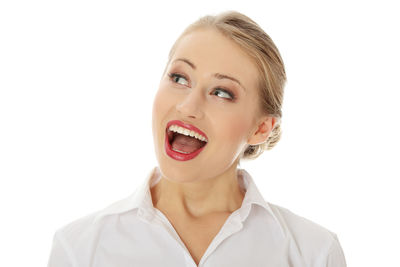 Portrait of smiling young woman against white background