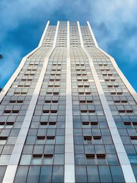 Low angle view of modern building against cloudy sky