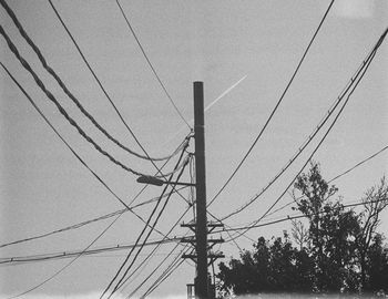 Low angle view of electricity pylon against sky