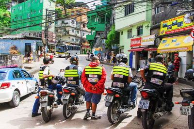 Rear view of police on road in city