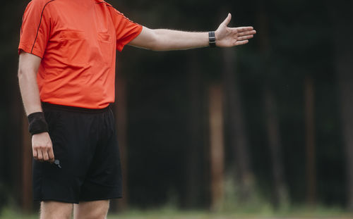 Midsection of man standing in park