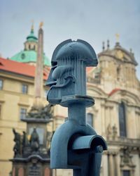 Low angle view of statue against building in city