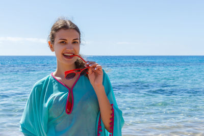 Portrait of smiling man in sea against sky