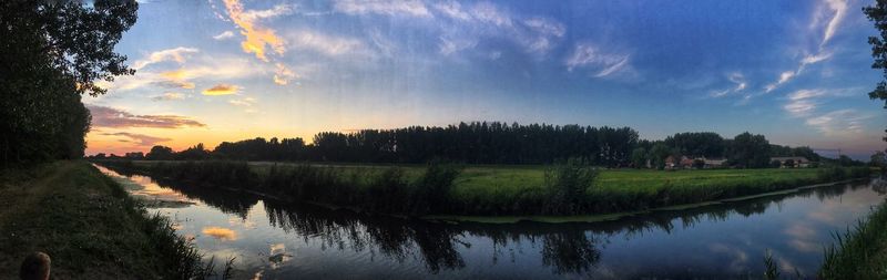 Scenic view of lake against sky at sunset