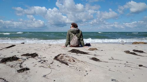 Scenic view of beach against cloudy sky