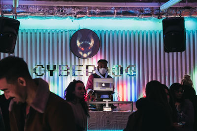 People standing in illuminated room