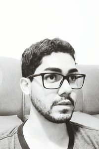 Portrait of young man wearing eyeglasses at home