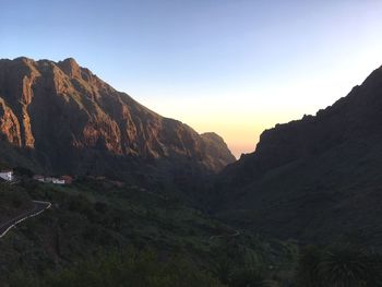 Scenic view of mountains against clear sky during sunset