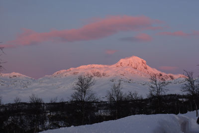 Scenic view of snowcapped mountains against sky at sunset