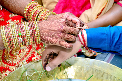 Midsection of couple holding hands