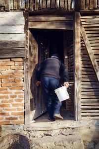 Rear view of man standing at entrance