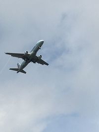 Low angle view of helicopter flying in sky