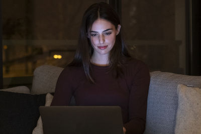 Young woman using laptop at home