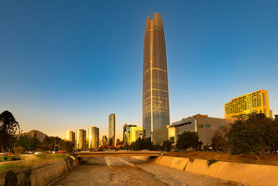 Skyline of buildings at providencia district with mapocho riverin the foreground, santiago de chile