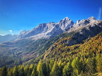 Scenic view of mountains against blue sky