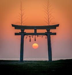 Silhouette gazebo against sky during sunset