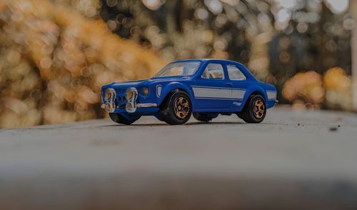 Close-up of toy blue car on road