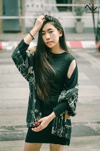Beautiful young woman standing in city