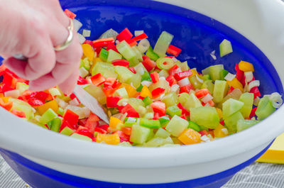 Close-up of hand holding salad in bowl