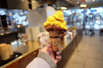 Person holding ice cream cone