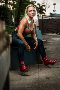 Portrait of young woman sitting outdoors