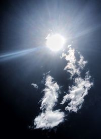 Low angle view of bright sun in sky