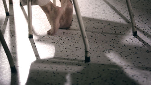 Low section of person sitting on chair