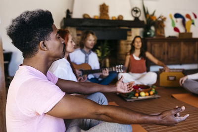 Man meditating at music therapy in farmhouse