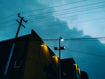 Low angle view of telephone pole against sky